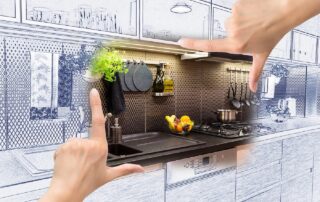Kitchen remodeling Toronto. 2 hands with blueprint.